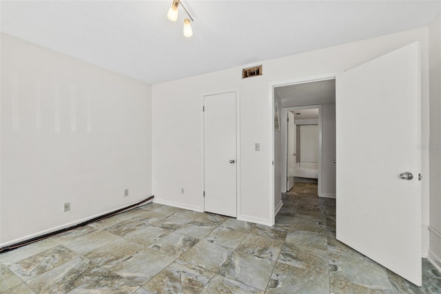 unfurnished bedroom featuring light tile floors