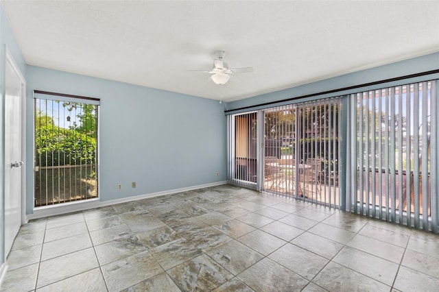 tiled spare room featuring ceiling fan