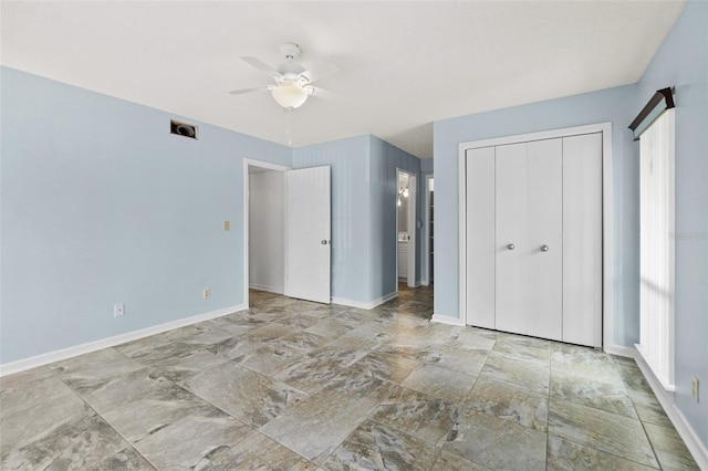 unfurnished bedroom featuring light tile flooring, a closet, and ceiling fan