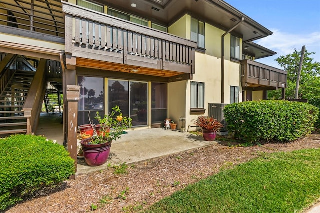 back of house with a balcony and a patio area