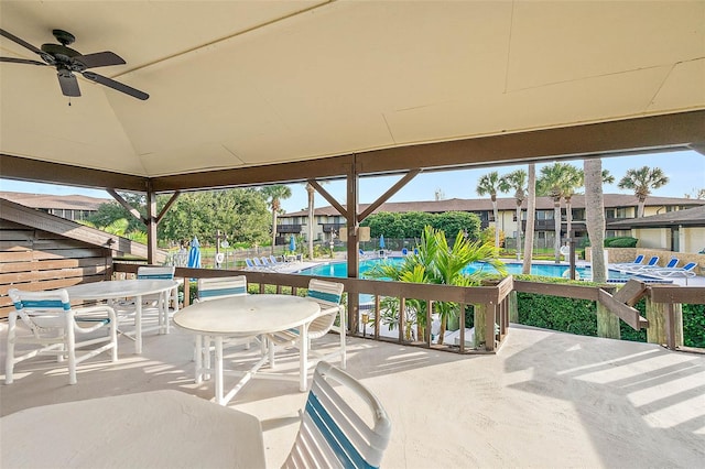 view of patio featuring a community pool and ceiling fan