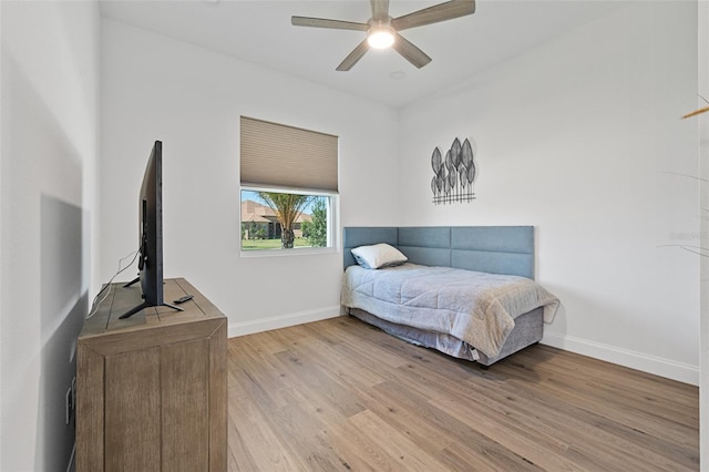 bedroom with ceiling fan and light hardwood / wood-style flooring