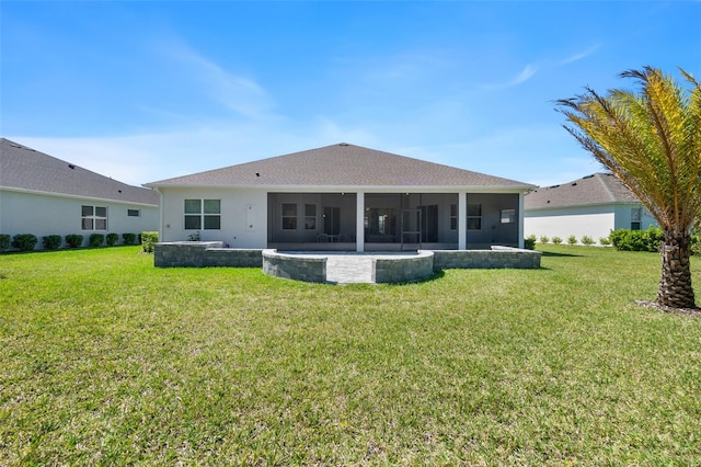 rear view of property with a patio and a lawn