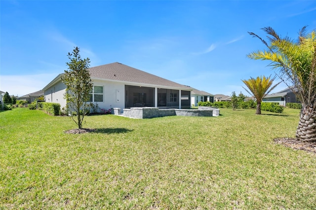 back of property with a sunroom and a lawn