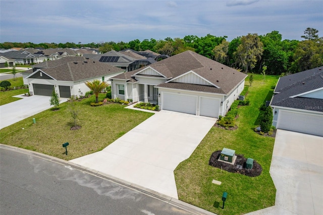 view of front of home with a front yard and a garage