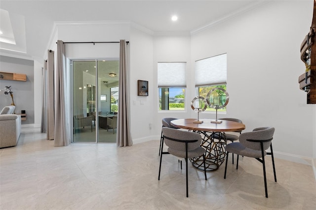 dining area featuring ornamental molding and light tile floors