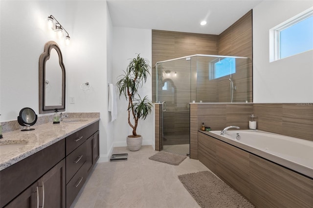 bathroom featuring tile flooring, plus walk in shower, and double vanity