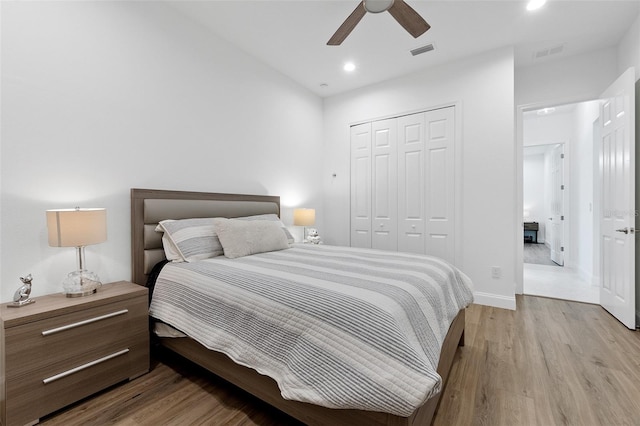 bedroom featuring ceiling fan, light hardwood / wood-style floors, and a closet