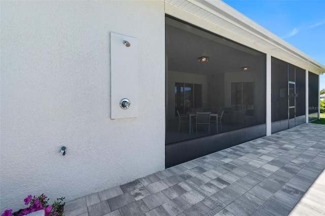 exterior space featuring a sunroom and a patio