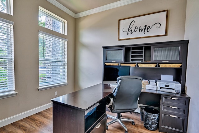 office featuring built in desk, dark wood-type flooring, and crown molding