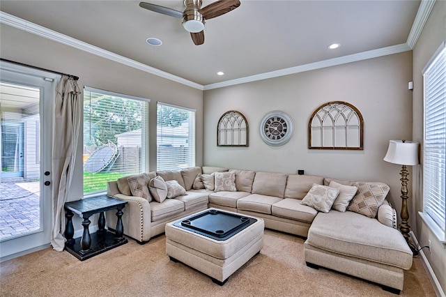 carpeted living room featuring ornamental molding and ceiling fan