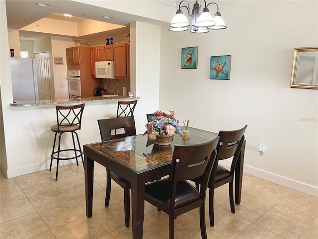 dining room with light tile patterned floors and a notable chandelier