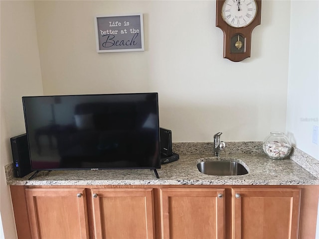 kitchen with sink and light stone counters