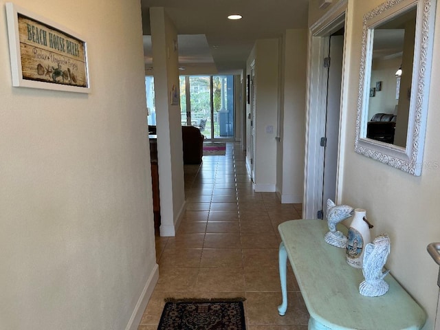 hall featuring dark tile patterned floors