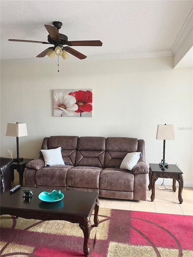 tiled living room with ceiling fan, ornamental molding, and a textured ceiling