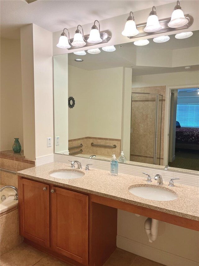 bathroom featuring vanity, separate shower and tub, and tile patterned floors