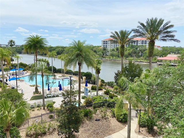 view of pool with a water view and a patio