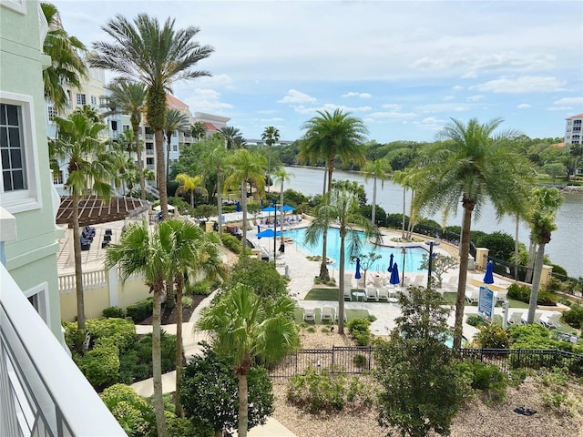 view of swimming pool featuring a patio and a water view