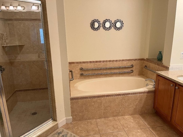 bathroom featuring vanity, shower with separate bathtub, and tile patterned floors