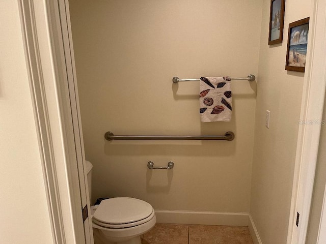 bathroom featuring toilet and tile patterned flooring