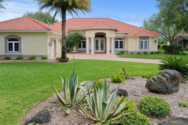 mediterranean / spanish-style house with french doors and a front lawn