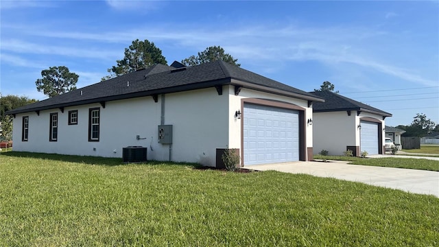 view of side of home featuring central AC, a garage, and a yard