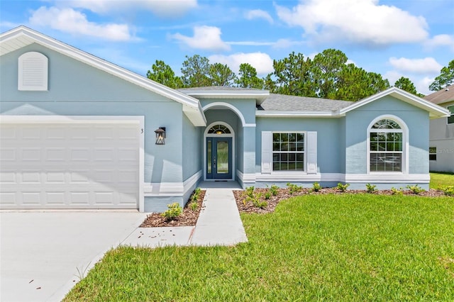 single story home with a garage and a front lawn