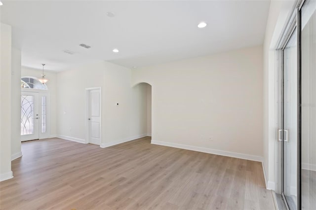 unfurnished room with light wood-type flooring