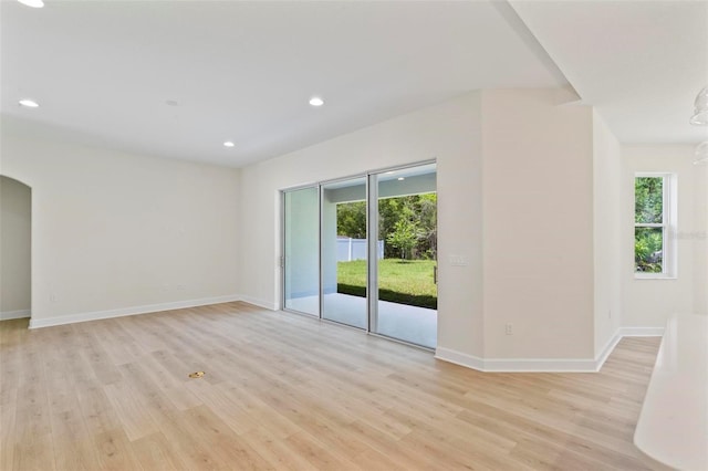 unfurnished room with light hardwood / wood-style floors and plenty of natural light