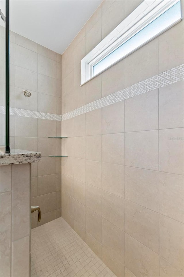 bathroom with tiled shower