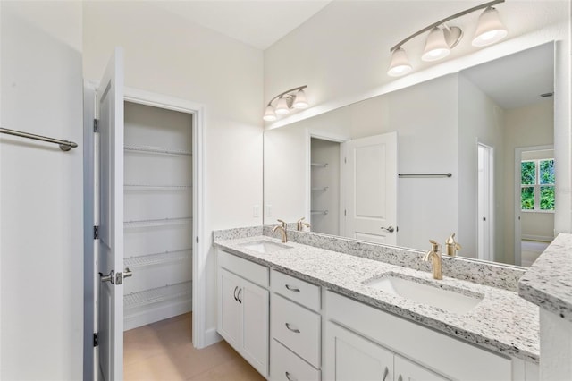 bathroom with tile patterned flooring and vanity