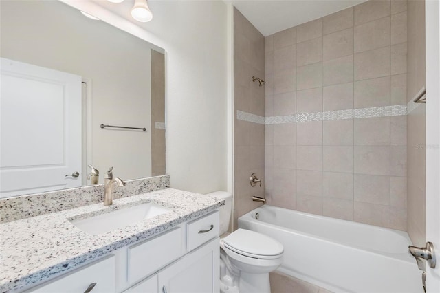 full bathroom with vanity, toilet, and tiled shower / bath