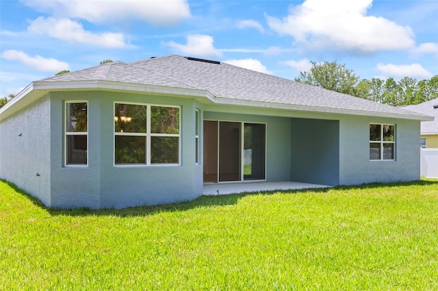 rear view of house featuring a lawn