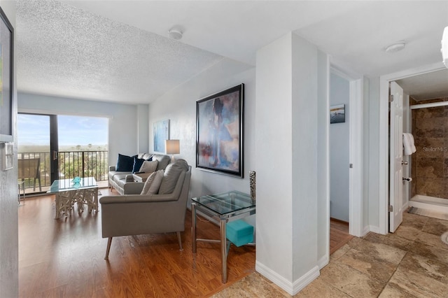 living room featuring light tile floors and a textured ceiling