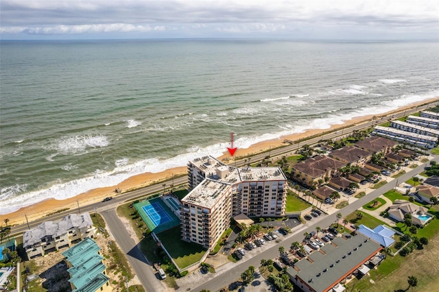 birds eye view of property with a beach view and a water view