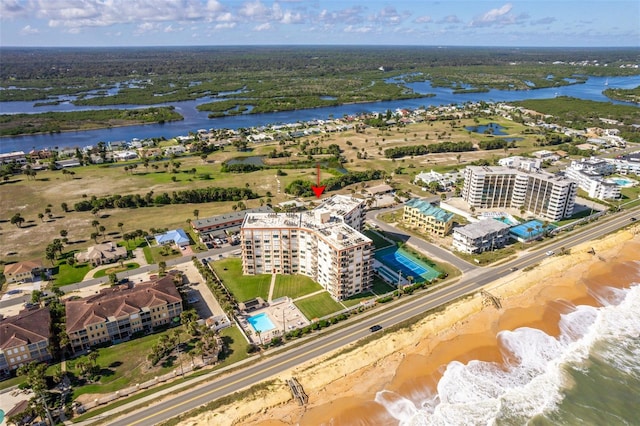 birds eye view of property featuring a beach view and a water view