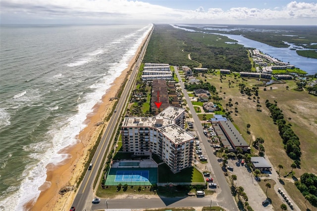 drone / aerial view featuring a view of the beach and a water view