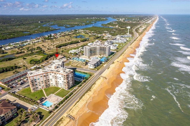 drone / aerial view featuring a beach view and a water view