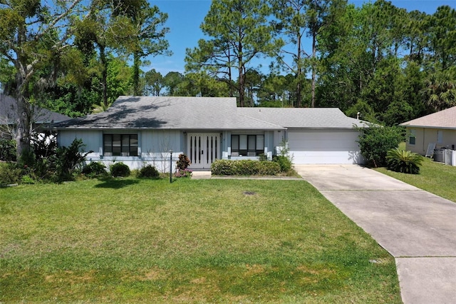 ranch-style home featuring a front yard and a garage