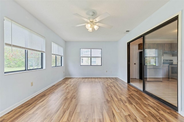 spare room with light hardwood / wood-style floors and ceiling fan