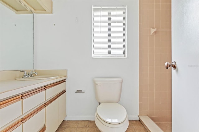 bathroom featuring toilet, vanity, and tile flooring