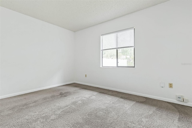 carpeted spare room with a textured ceiling