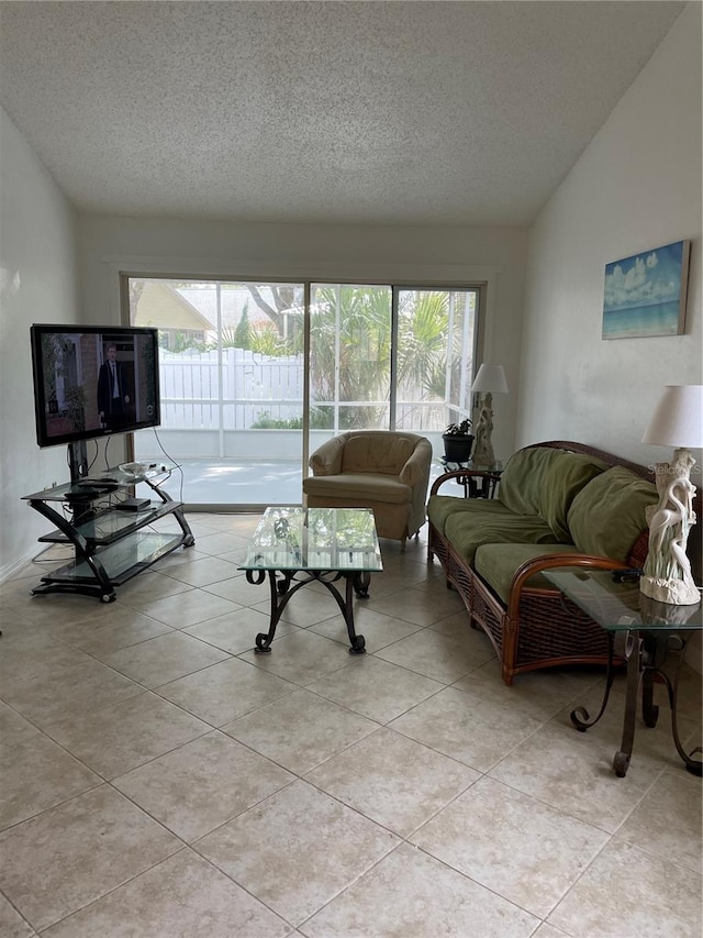 living room featuring a textured ceiling, vaulted ceiling, and light tile patterned floors