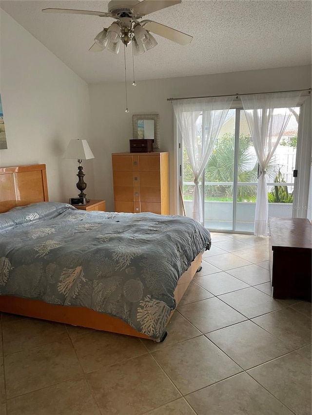 tiled bedroom with a textured ceiling, ceiling fan, and access to outside