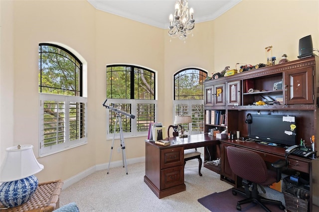 carpeted office space featuring a chandelier, a high ceiling, and a wealth of natural light