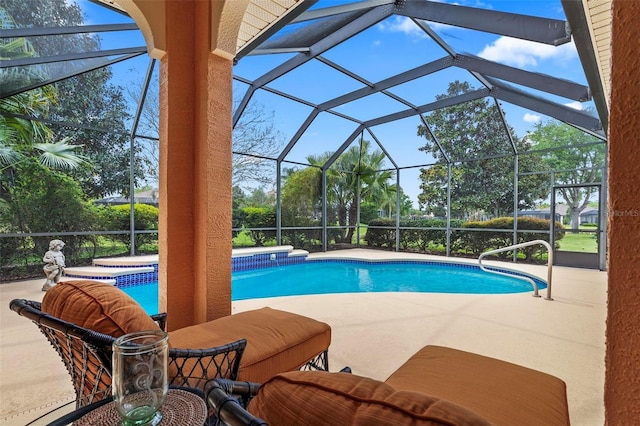 view of swimming pool featuring a patio, a hot tub, and a lanai