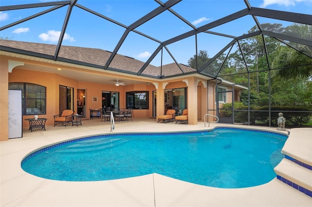 view of swimming pool with a lanai, ceiling fan, and a patio