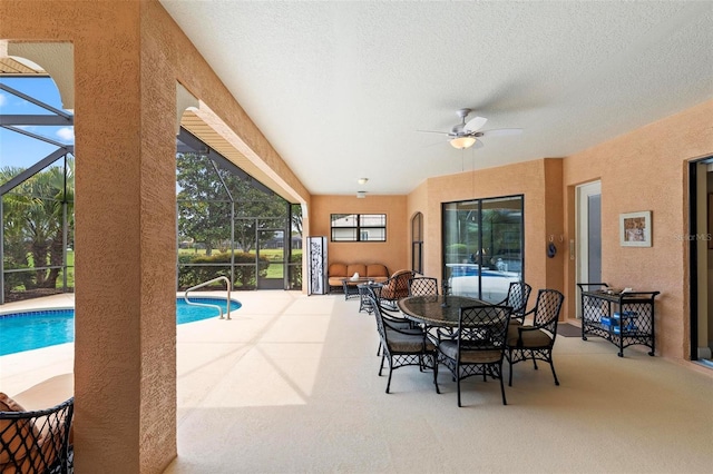 carpeted dining room featuring a textured ceiling and ceiling fan