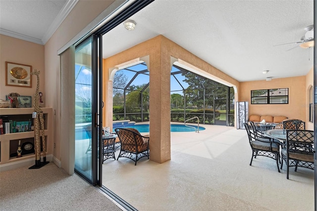 interior space with ceiling fan and a swimming pool