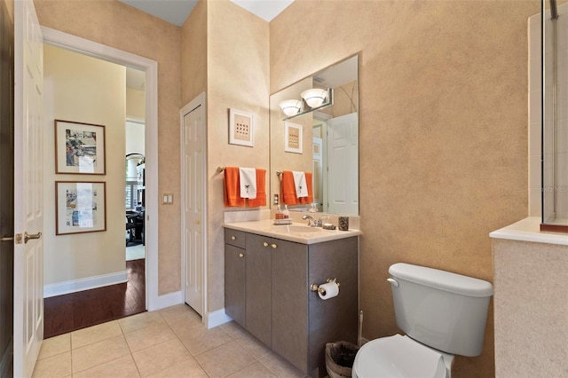 bathroom with tile patterned floors, vanity, and toilet